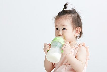 Asian infant drinking milk