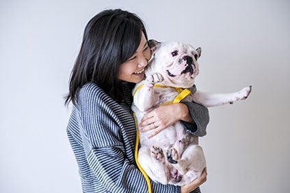 Chinese woman holding pet dog