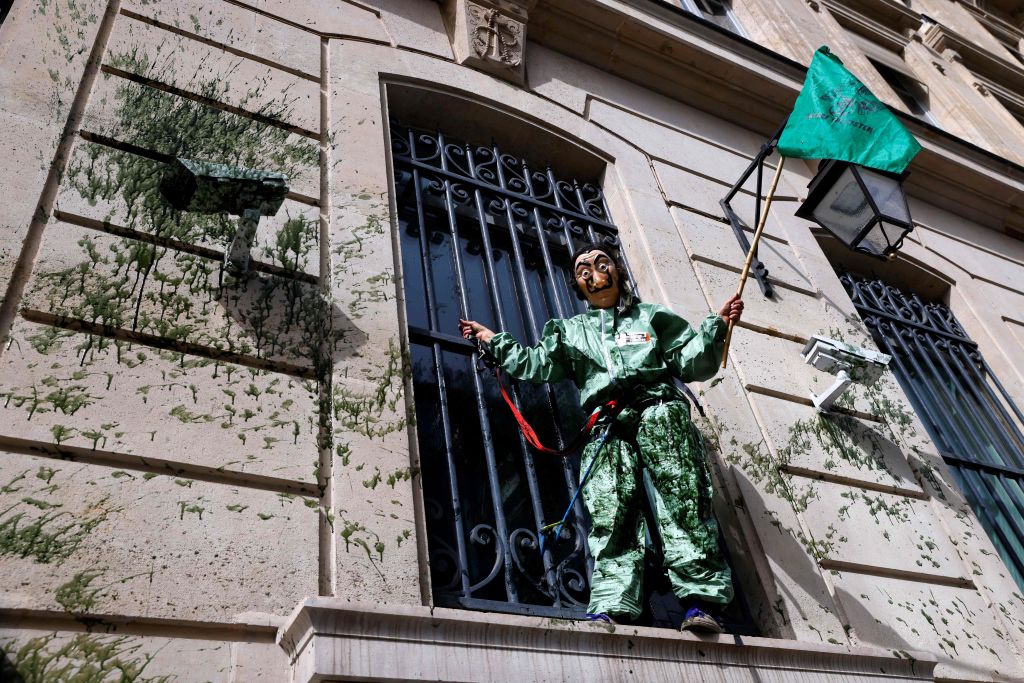 Environmental activist protests at the Banque de France, Paris in April 2021