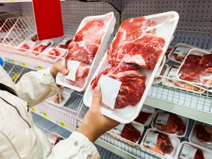 Customer buying pork meat in supermarket