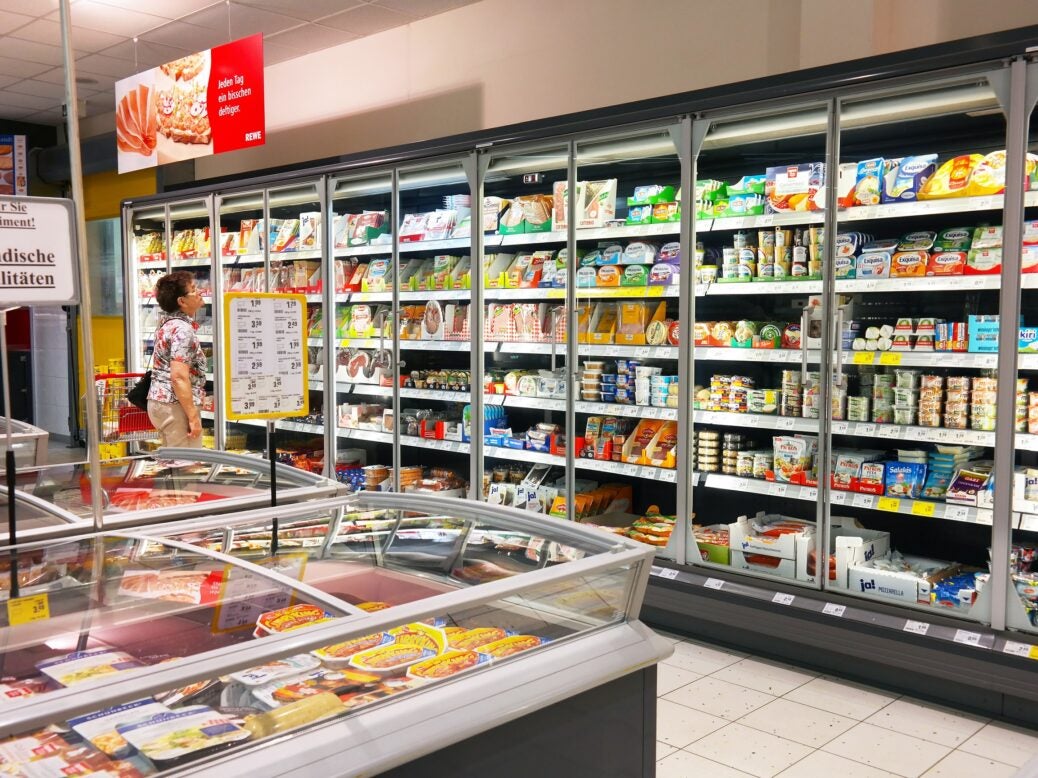 Woman shopping in the refrigerated fresh products aisle of a Rewe supermarket, Waldfeucht, Germany, 11 May 2016