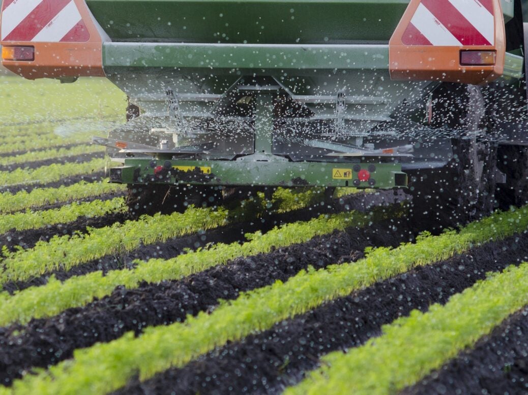 Farmer sprays fertiliser on crops