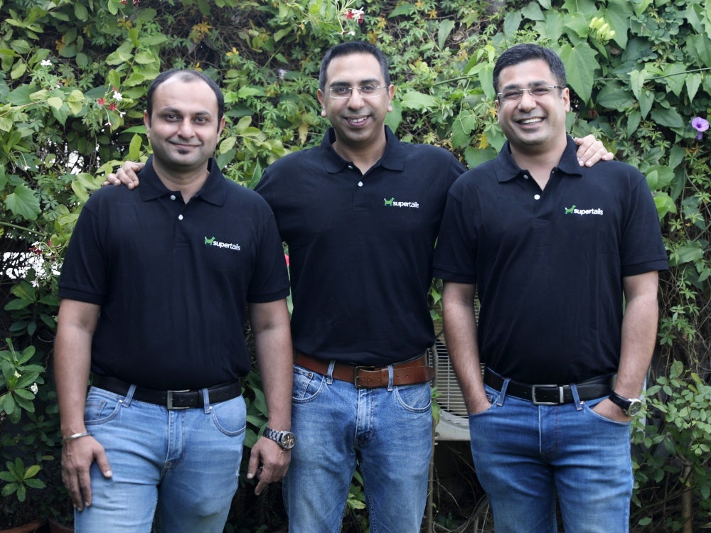 Three pet food company co founders in India stand side by side smiling