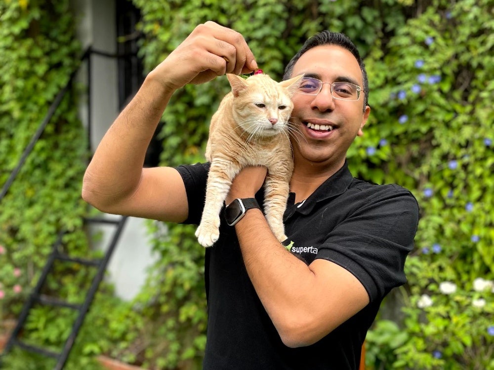 Varun Sadana with his pet ginger cat on his shoulder