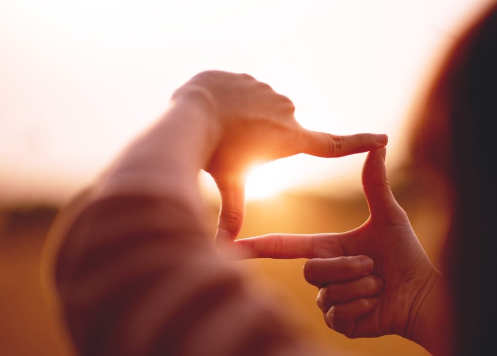 Sun shining through fingers