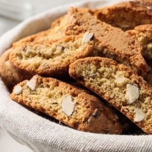 Traditional Italian almond biscuits (Cantucci) in basket on table, closeup