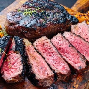 Barbequed rib-eye beef sliced on a board
