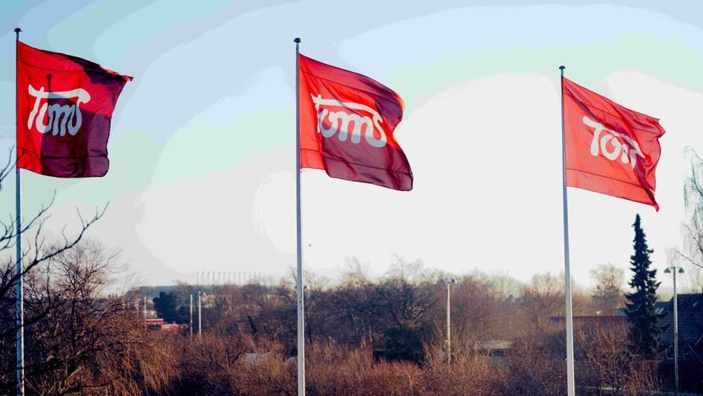 Toms Group corporate emblem on flags